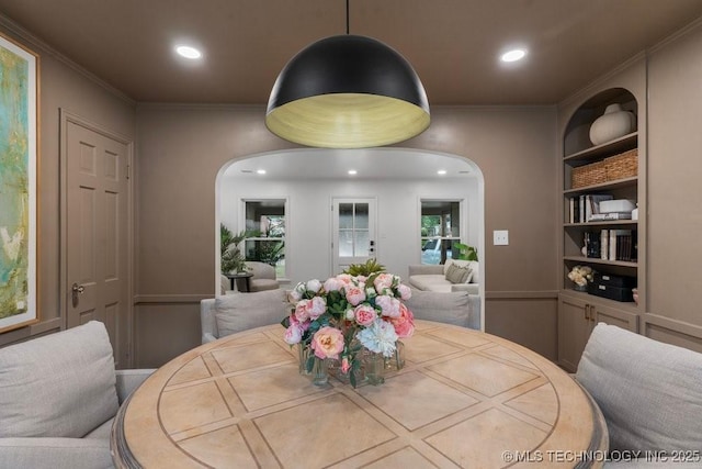 4723 E 8th St, Tulsa, OK 74112 - dining room with built in features, ornamental molding, arched walkways, recessed lighting, and healthy amount of natural light