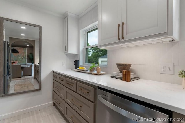 4723 E 8th St, Tulsa, OK 74112 - kitchen featuring appliances with stainless steel finishes, backsplash, light countertops, baseboards, and ornamental molding