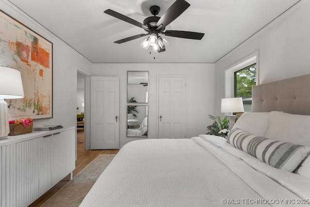 4723 E 8th St, Tulsa, OK 74112 - bedroom with light wood-type flooring, radiator, and a ceiling fan