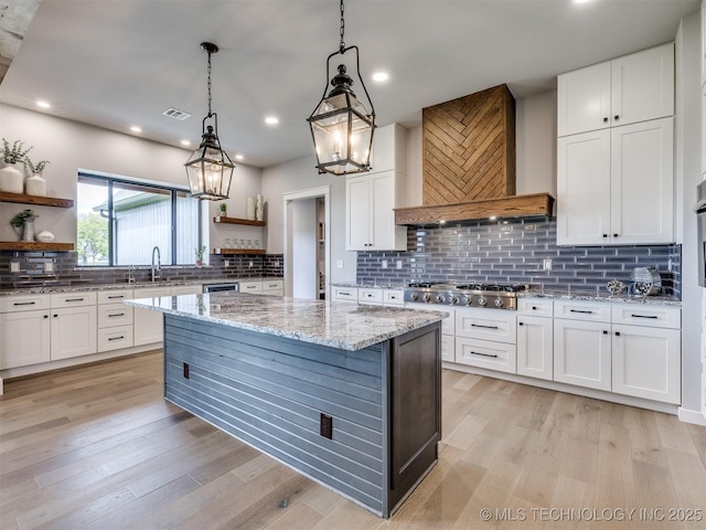 3241 E 171st St S, Bixby, OK 74008 - kitchen featuring open shelves, custom range hood, stainless steel gas cooktop, white cabinetry, and tasteful backsplash