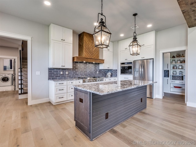 3241 E 171st St S, Bixby, OK 74008 - kitchen featuring stainless steel appliances, washer / dryer, custom range hood, white cabinetry, and recessed lighting