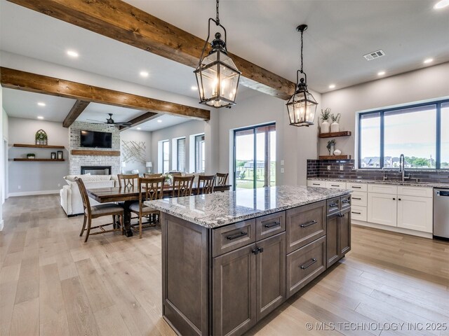 3241 E 171st St S, Bixby, OK 74008 - kitchen with stainless steel dishwasher, beamed ceiling, white cabinets, light stone countertops, and ceiling fan