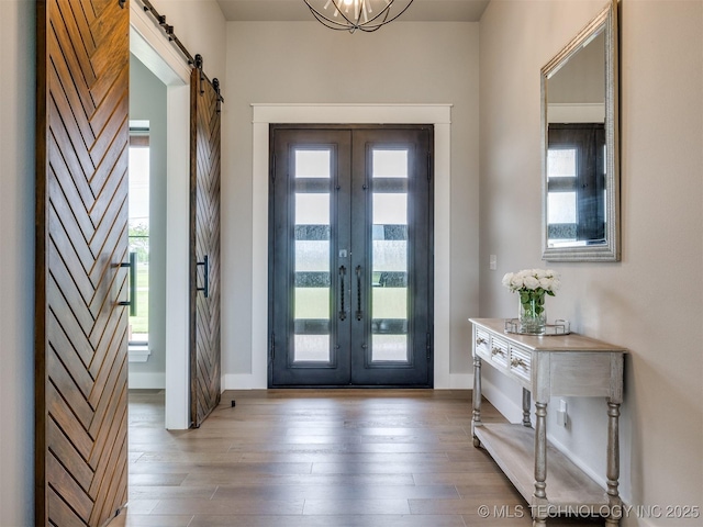 3241 E 171st St S, Bixby, OK 74008 - entryway with french doors, a barn door, baseboards, and wood finished floors