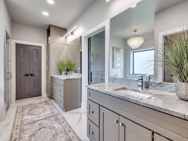 3241 E 171st St S, Bixby, OK 74008 - full bathroom with marble finish floors, two vanities, a chandelier, a shower stall, and recessed lighting