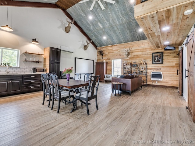 3241 E 171st St S, Bixby, OK 74008 - dining area featuring heating unit, wood walls, a wall mounted air conditioner, high vaulted ceiling, and light wood finished floors