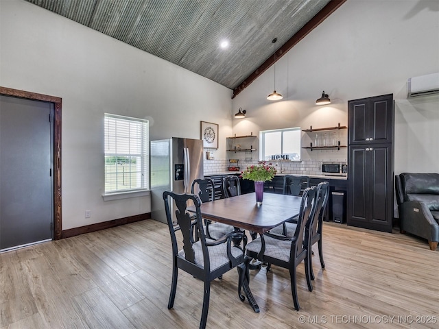 3241 E 171st St S, Bixby, OK 74008 - dining area with a wall unit AC, high vaulted ceiling, light wood-style flooring, and baseboards