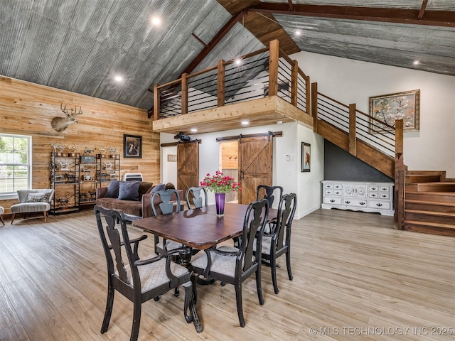 3241 E 171st St S, Bixby, OK 74008 - dining area featuring high vaulted ceiling, a barn door, stairway, wood finished floors, and recessed lighting