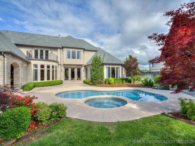 view of swimming pool featuring an in-ground hot tub, french doors, fence, and a patio area
