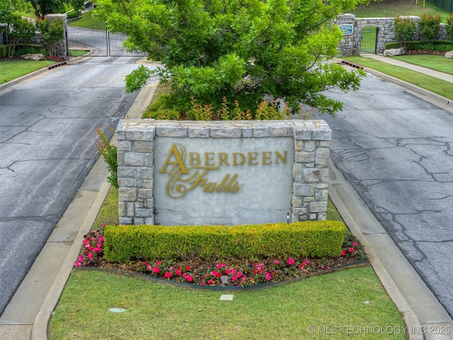community sign featuring a gate and fence
