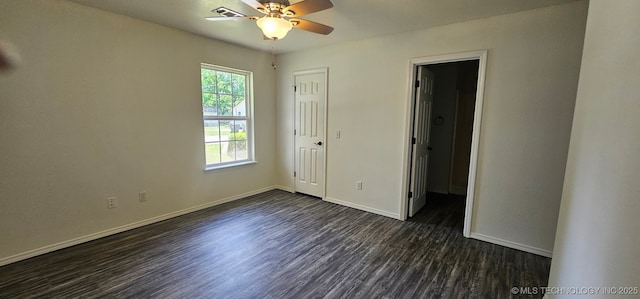 103 E Iola, Sallisaw, OK 74955 - unfurnished bedroom with dark wood-style floors, baseboards, and ceiling fan