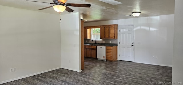 103 E Iola, Sallisaw, OK 74955 - kitchen with a sink, dishwasher, dark countertops, dark wood-type flooring, and a textured ceiling