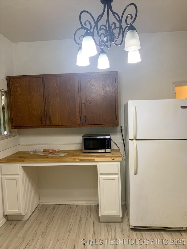 303 W Conklin, Sparks, OK 74869 - kitchen with freestanding refrigerator, stainless steel microwave, butcher block counters, white cabinetry, and light wood finished floors