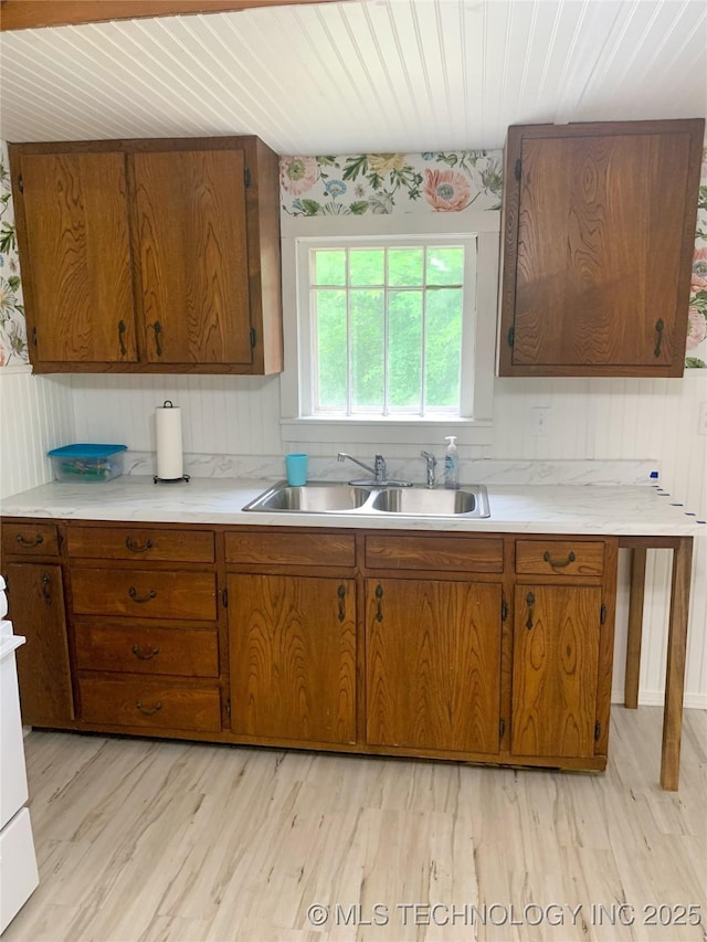 303 W Conklin, Sparks, OK 74869 - kitchen featuring a sink, brown cabinets, light countertops, wood ceiling, and wood walls