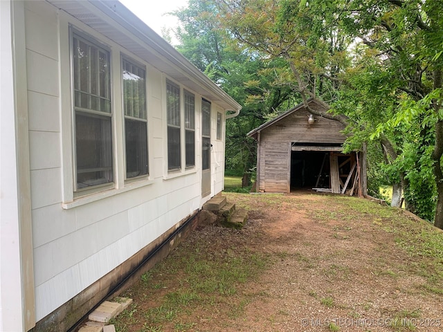 303 W Conklin, Sparks, OK 74869 - view of side of home featuring an outdoor structure and entry steps