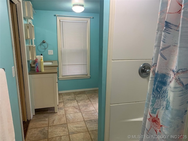 303 W Conklin, Sparks, OK 74869 - bathroom with stone finish floors, a shower with curtain, baseboards, and vanity
