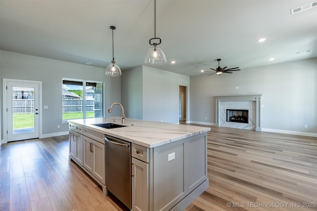 kitchen with a sink, stainless steel dishwasher, a ceiling fan, light wood finished floors, and recessed lighting