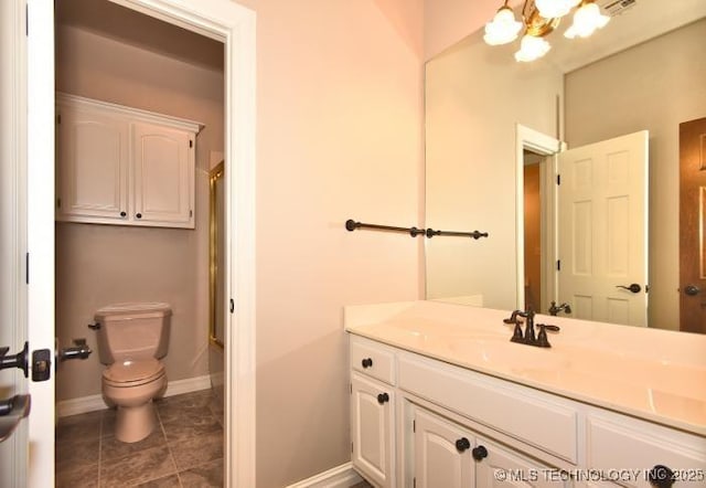 8734 S Richmond Ave, Tulsa, OK 74137 - full bathroom featuring vanity, toilet, a chandelier, baseboards, and tile patterned floors