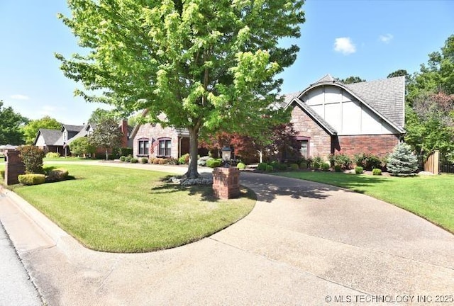 8734 S Richmond Ave, Tulsa, OK 74137 - tudor house featuring stone siding and a front lawn