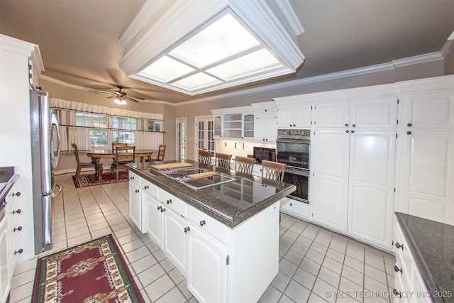 8734 S Richmond Ave, Tulsa, OK 74137 - kitchen featuring black appliances, light tile patterned flooring, a ceiling fan, a center island, and ornamental molding
