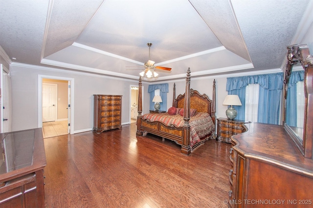 8734 S Richmond Ave, Tulsa, OK 74137 - bedroom featuring a raised ceiling, wood finished floors, baseboards, ornamental molding, and a ceiling fan