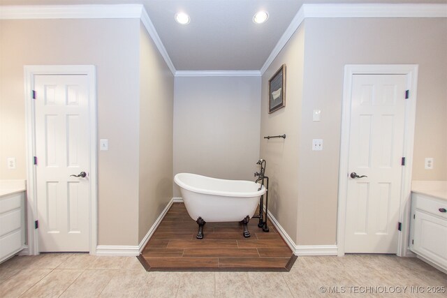 8734 S Richmond Ave, Tulsa, OK 74137 - full bath featuring vanity, a freestanding bath, ornamental molding, baseboards, and recessed lighting