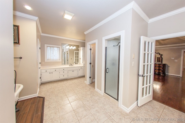 8734 S Richmond Ave, Tulsa, OK 74137 - full bath with double vanity, crown molding, a shower stall, a chandelier, and baseboards