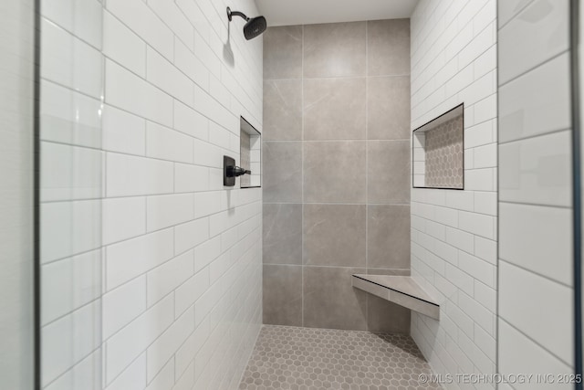 full bathroom featuring tiled shower