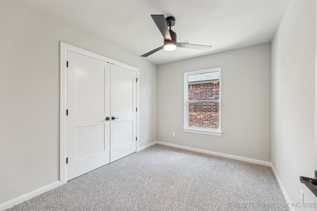 unfurnished bedroom featuring carpet, a closet, and baseboards