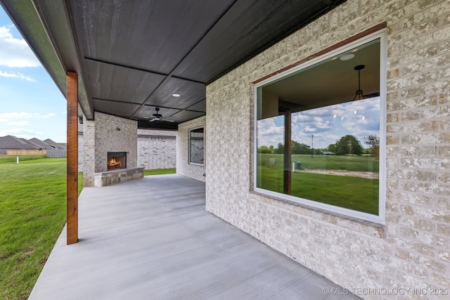 view of patio / terrace with a fireplace and ceiling fan