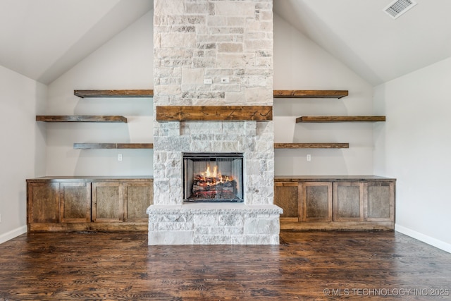 unfurnished living room with lofted ceiling, wood finished floors, a fireplace, and baseboards
