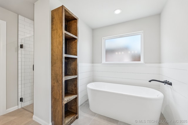 bathroom featuring a freestanding tub, tile patterned floors, a shower stall, and recessed lighting