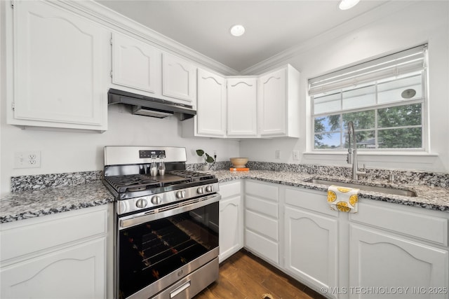 kitchen with stainless steel range with gas stovetop, under cabinet range hood, a sink, white cabinetry, and light stone counters