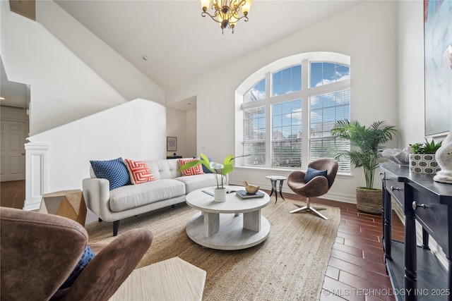 living room featuring wood finished floors, a chandelier, and high vaulted ceiling