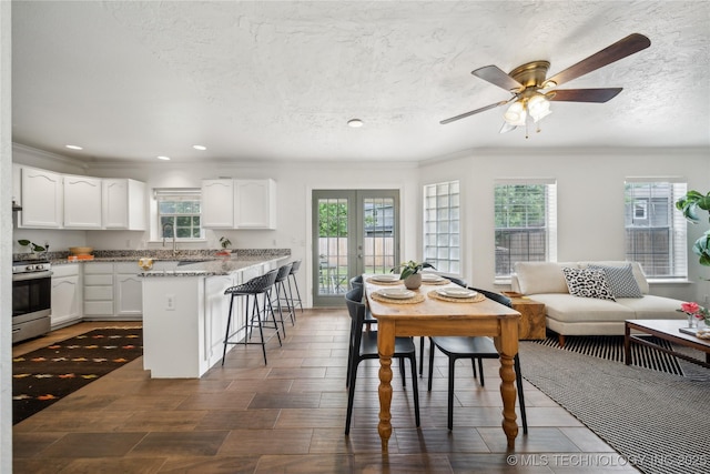 dining space with ornamental molding, recessed lighting, french doors, ceiling fan, and a textured ceiling