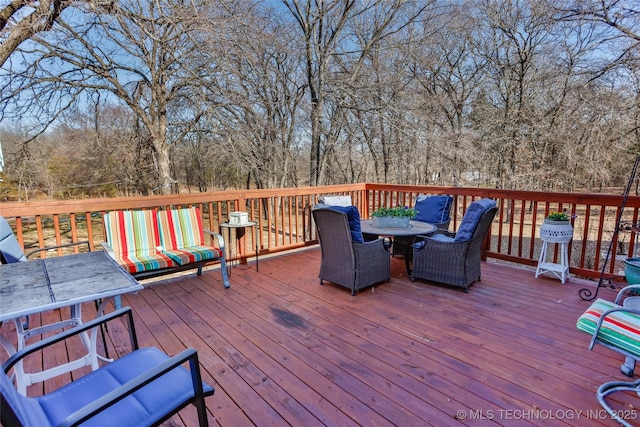 10862 Hide-A-Way, Thackerville, OK 73459 - wooden deck featuring outdoor dining area and view of wooded area