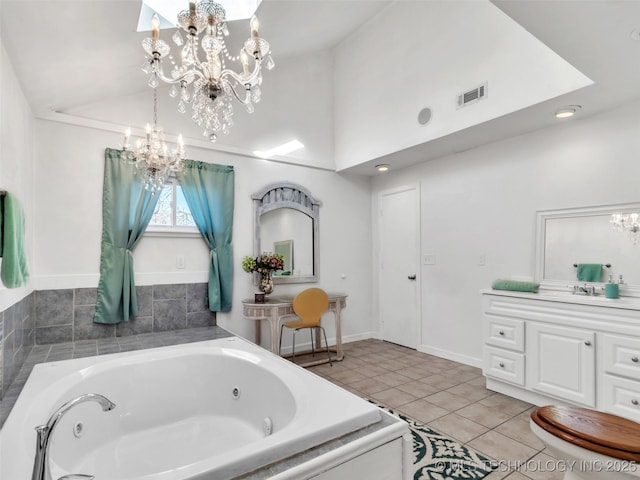 410 W B J Tunnell, Miami, OK 74354 - bathroom with a chandelier, a whirlpool tub, tile patterned floors, lofted ceiling, and vanity