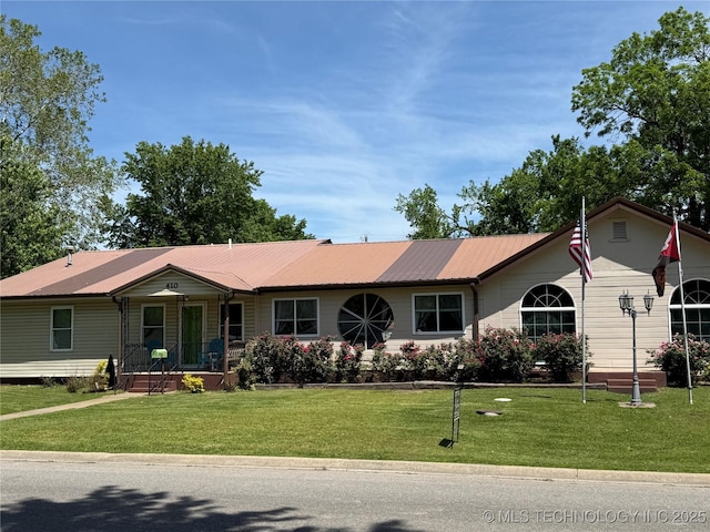 410 W B J Tunnell, Miami, OK 74354 - single story home featuring covered porch, a front lawn, and metal roof