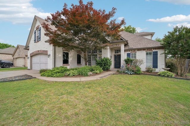 7204 E 92nd St, Tulsa, OK 74133 - french country style house featuring concrete driveway, roof with shingles, a front lawn, brick siding, and a garage