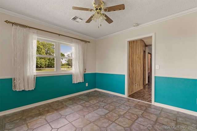 empty room with a textured ceiling, a ceiling fan, crown molding, a smoke detector, and stone finish flooring