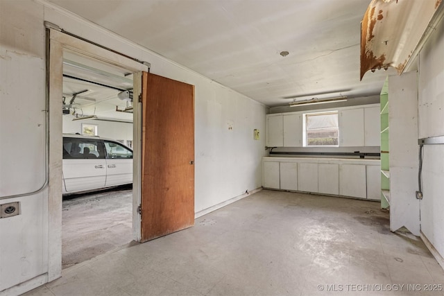 kitchen with white cabinets and concrete flooring