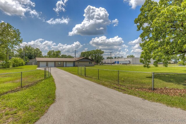 view of front of house featuring asphalt driveway and an attached garage