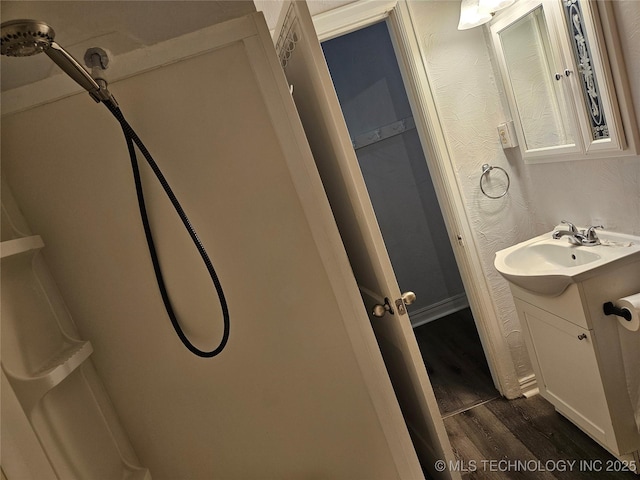 1435 E Oak St, Cushing, OK 74023 - bathroom with wood finished floors and vanity