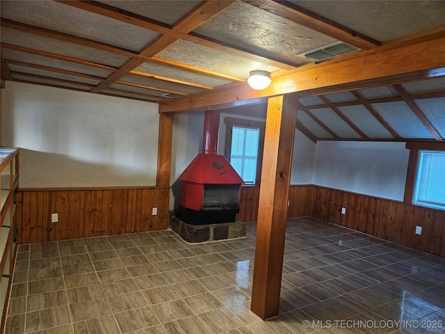 1435 E Oak St, Cushing, OK 74023 - bonus room with wood walls, a wood stove, and wainscoting