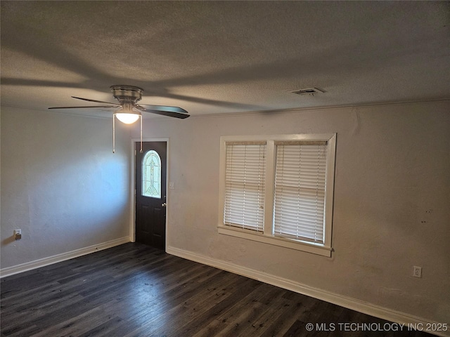 1435 E Oak St, Cushing, OK 74023 - foyer featuring dark wood finished floors, a textured ceiling, baseboards, and a ceiling fan