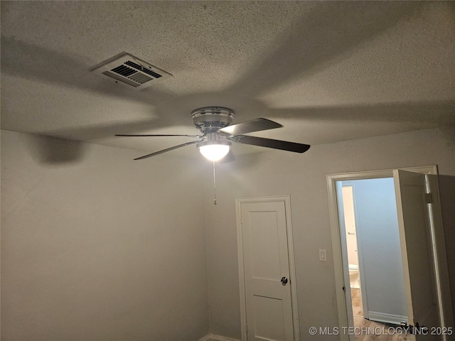 1435 E Oak St, Cushing, OK 74023 - detailed view of a textured ceiling, ceiling fan, and baseboards