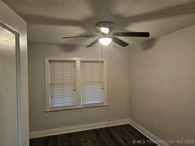 1435 E Oak St, Cushing, OK 74023 - spare room featuring dark wood finished floors, a textured ceiling, baseboards, and a ceiling fan