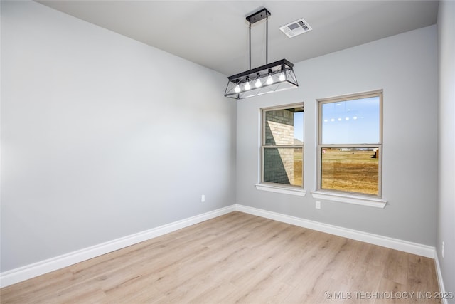 250 Maple Leaf Dr, Durant, OK 74701 - unfurnished dining area with wood finished floors and baseboards