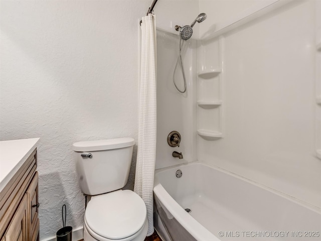 full bath featuring a textured wall, vanity, toilet, and shower / bath combo