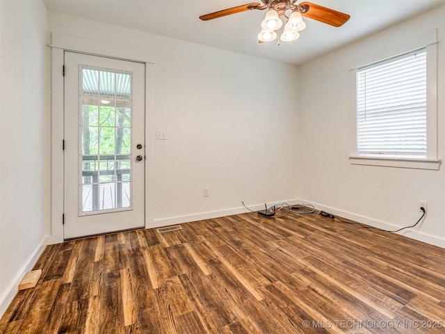 unfurnished room featuring wood finished floors, a ceiling fan, and baseboards