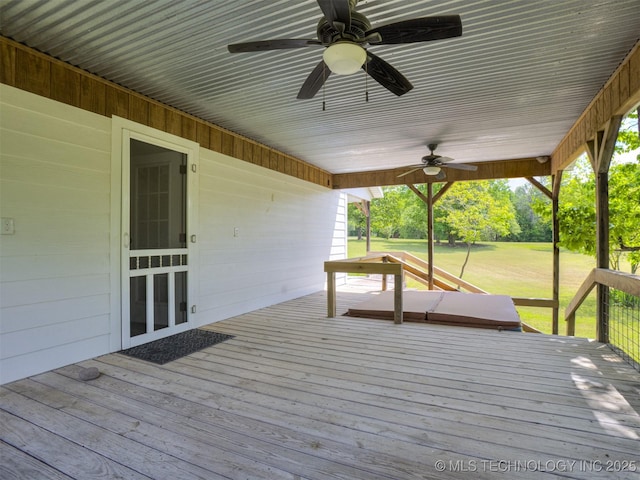 wooden deck featuring ceiling fan and a lawn